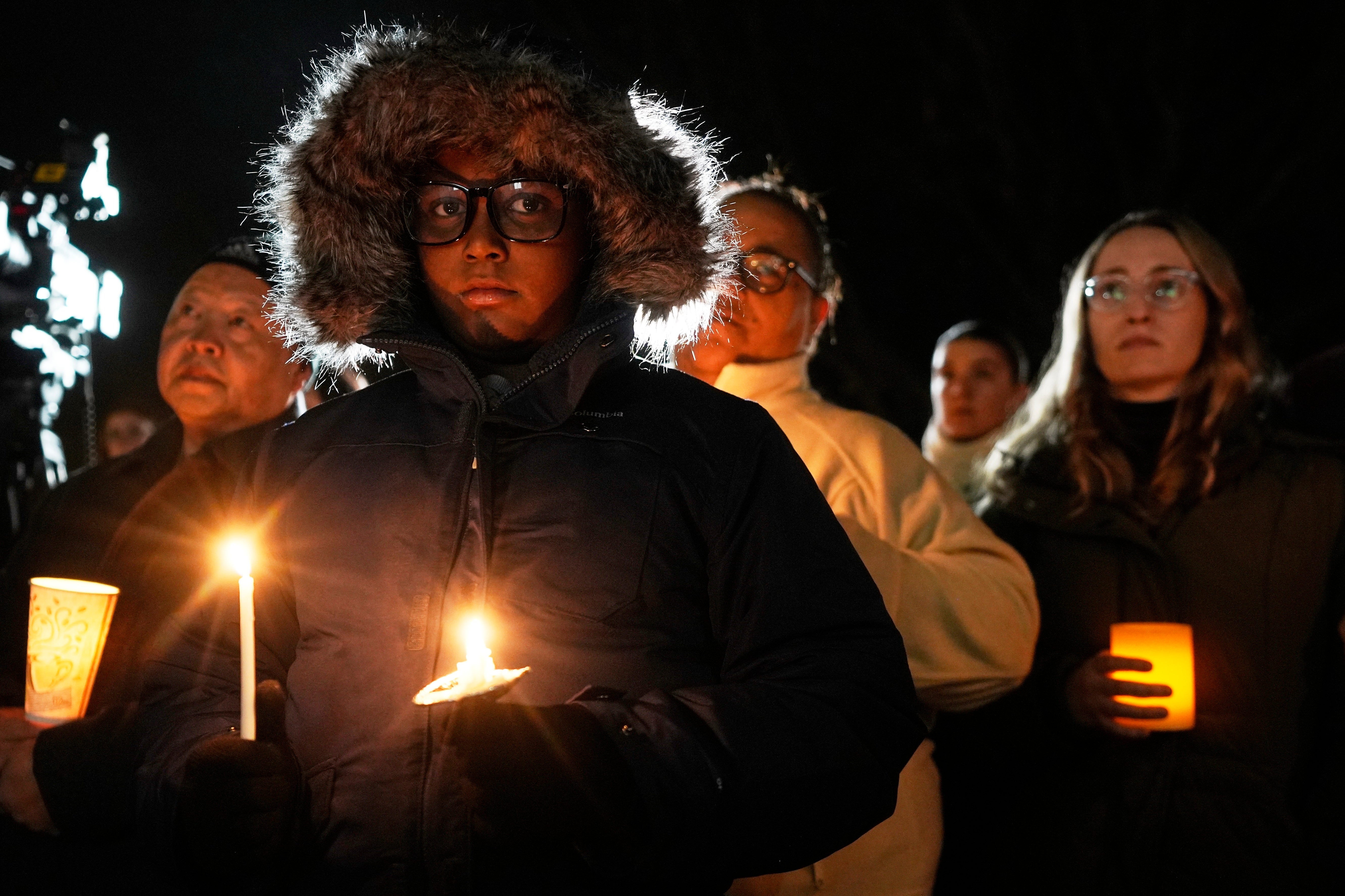 Supporters hold candles during a candlelight vigil Tuesday outside the Wisconsin Capitol in Madison