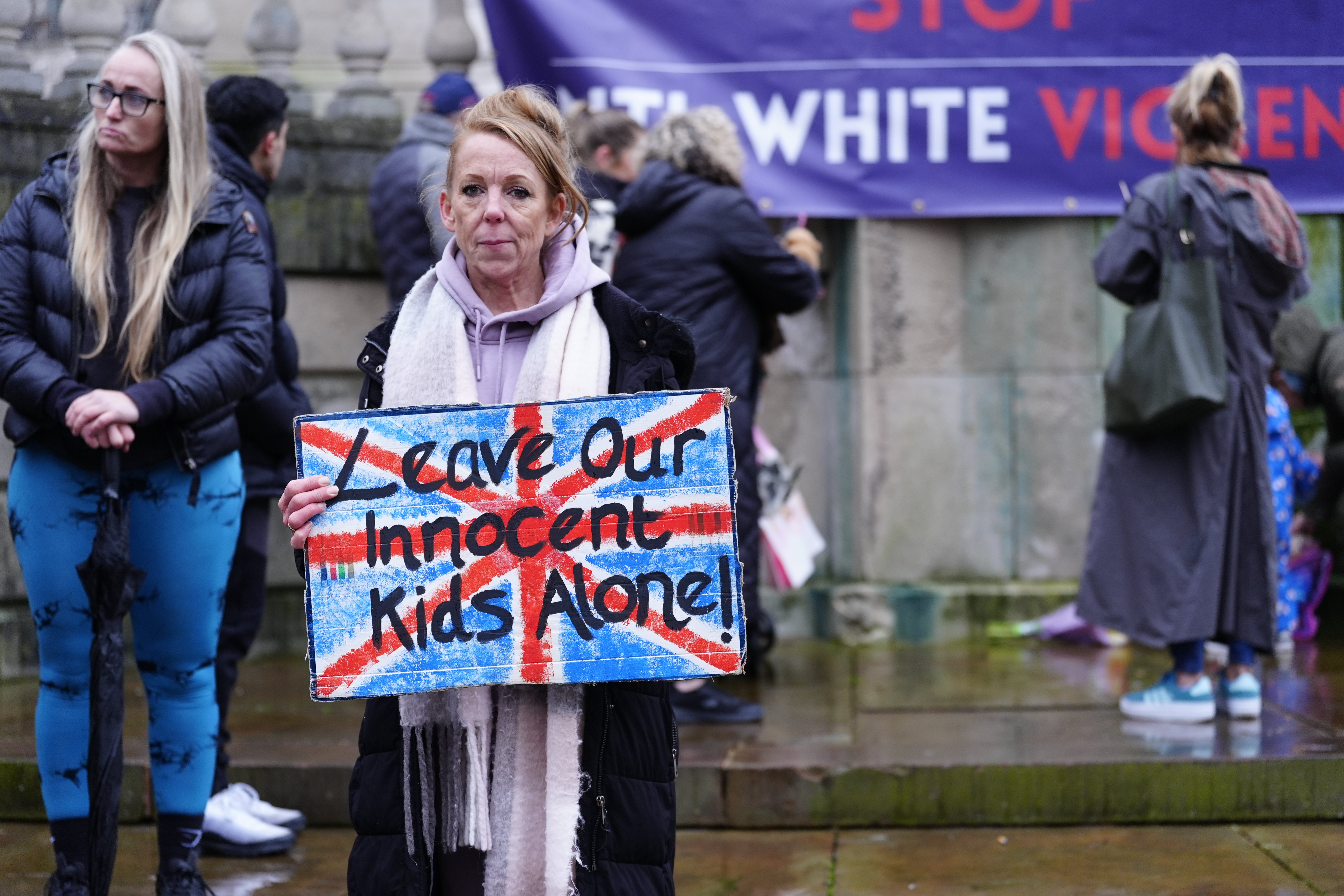 Her placard reads ‘Leave our Innocent Kids Alone’