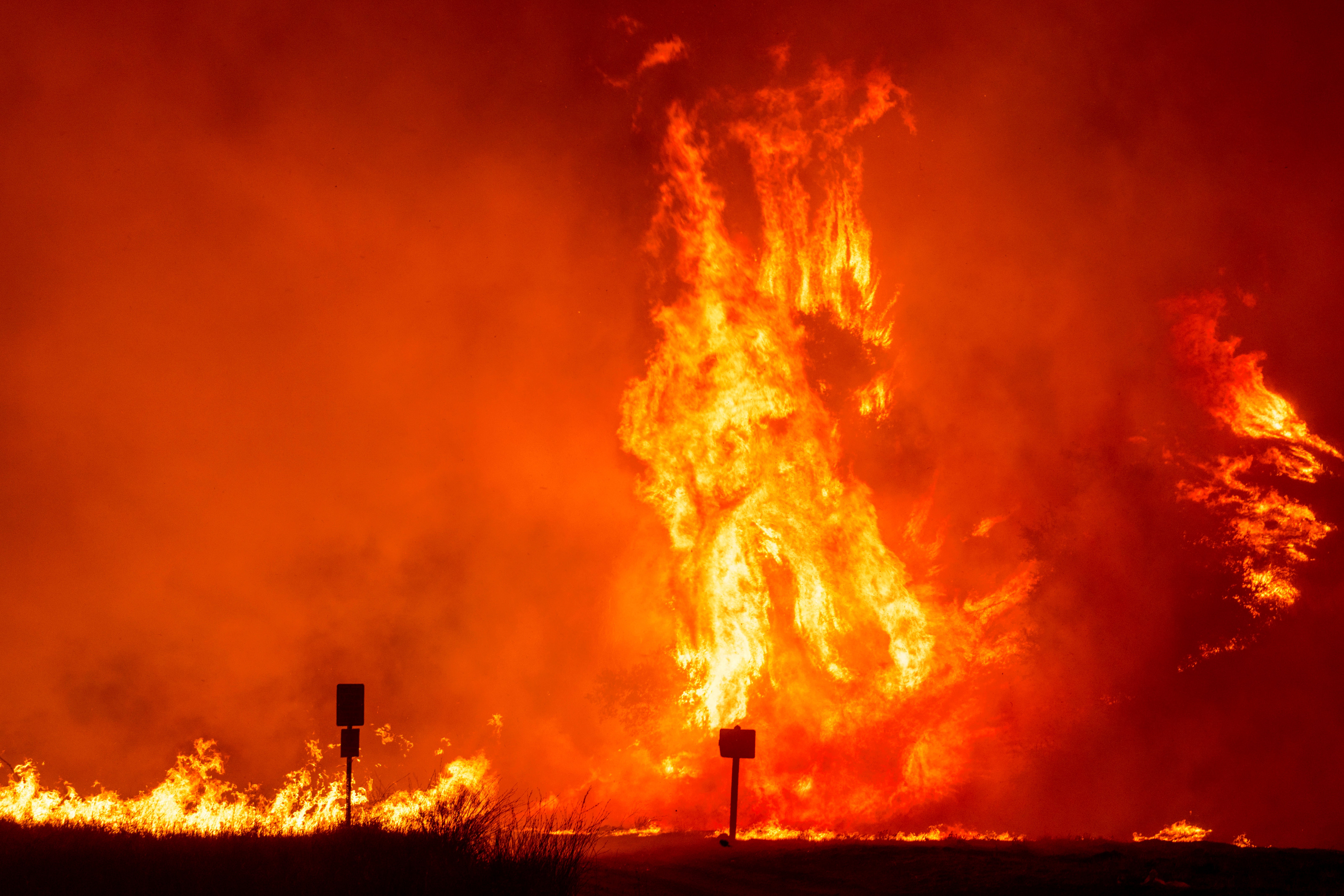 Flames roar as the Hughes Fire burns trees in Castaic