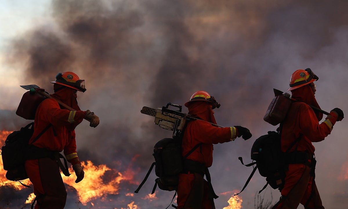 Inmate firefighters work as the Hughes Fire burns north of Los Angeles