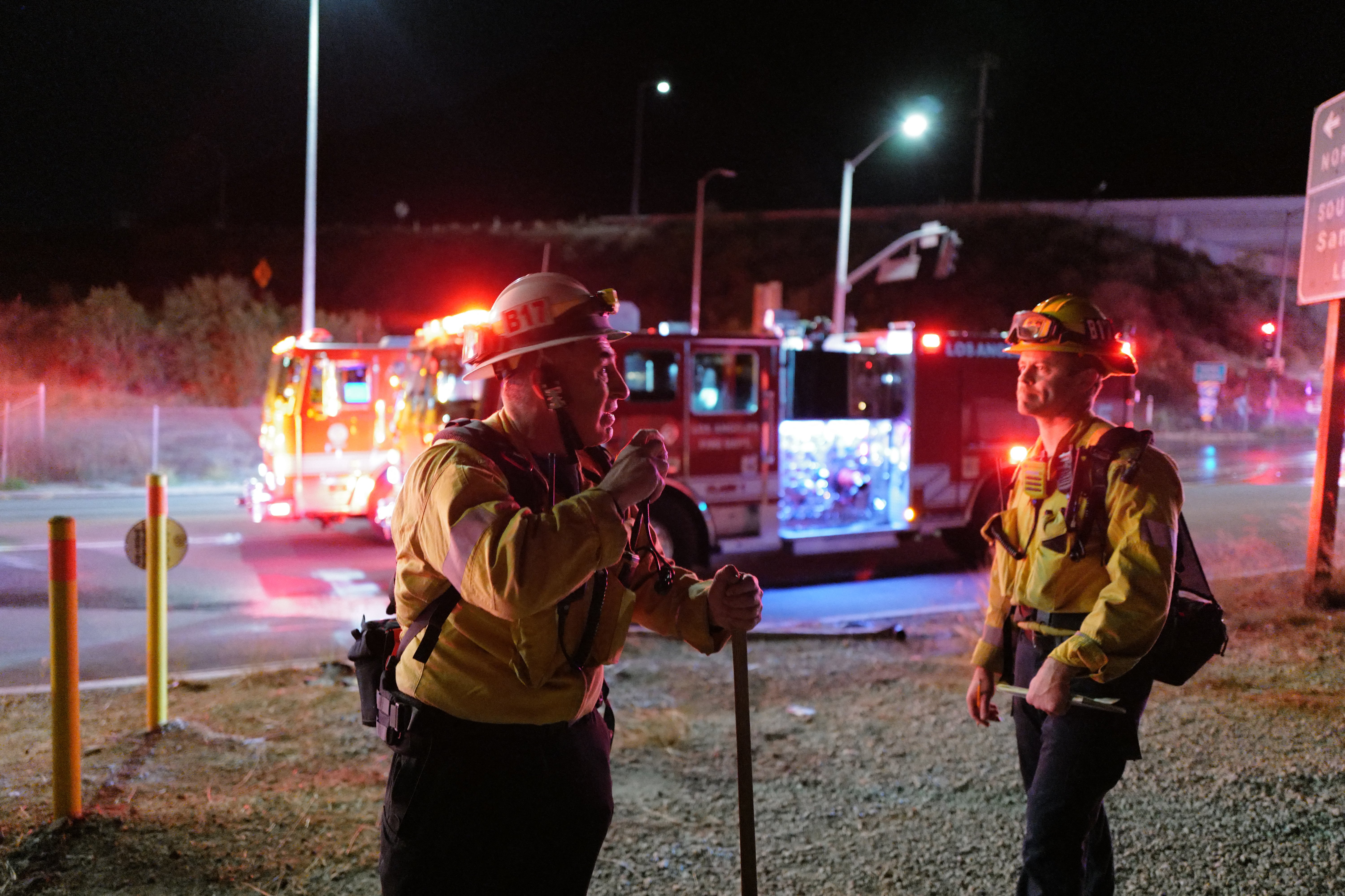 Firefighters work while the Sepulveda fire is burning in Los Angeles, California, on Thursday. The wildfire broke out in the early hours of the morning