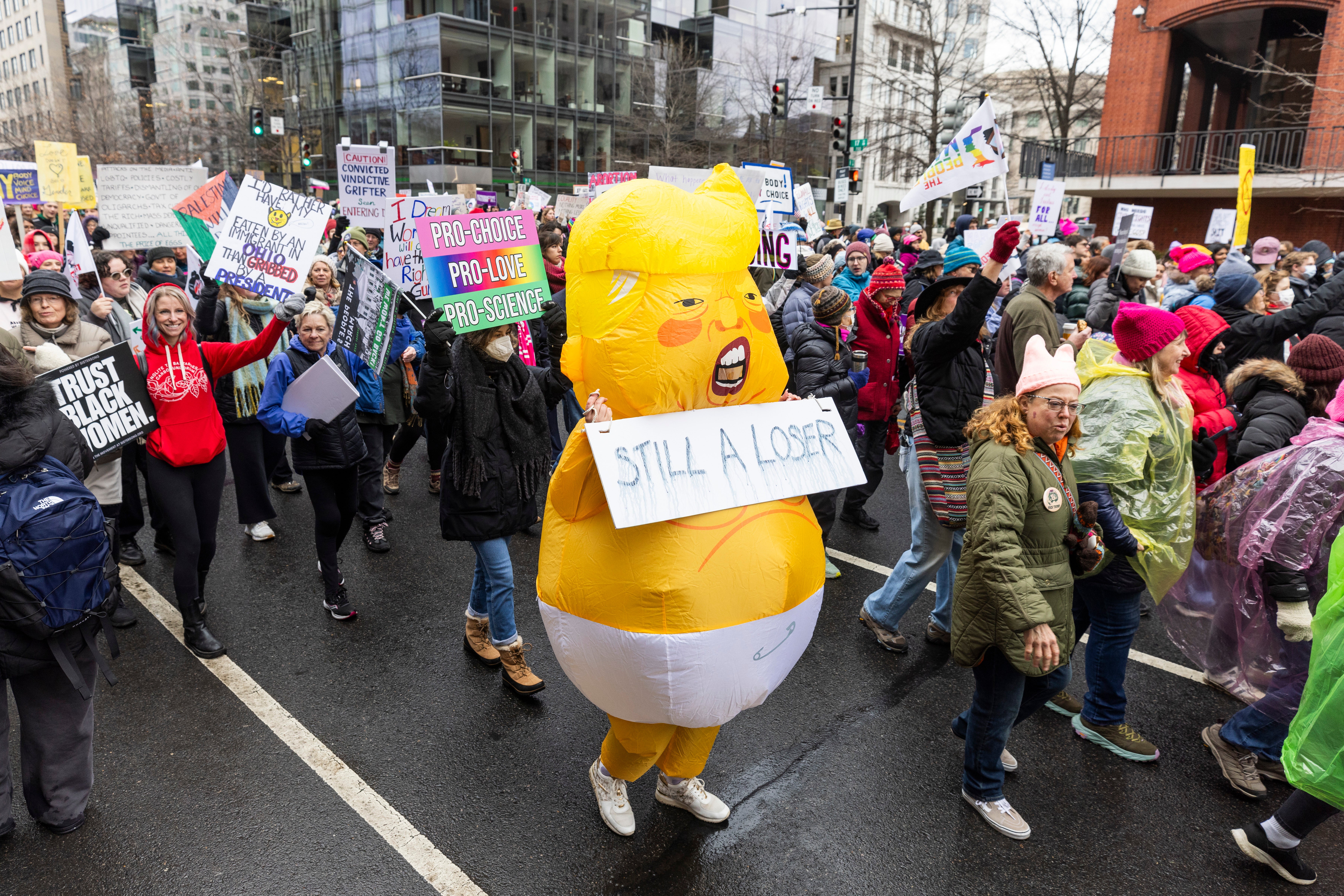 Participants in the People's March, a rally opposing the incoming Trump administration, march to the Lincoln Memorial in Washington, DC