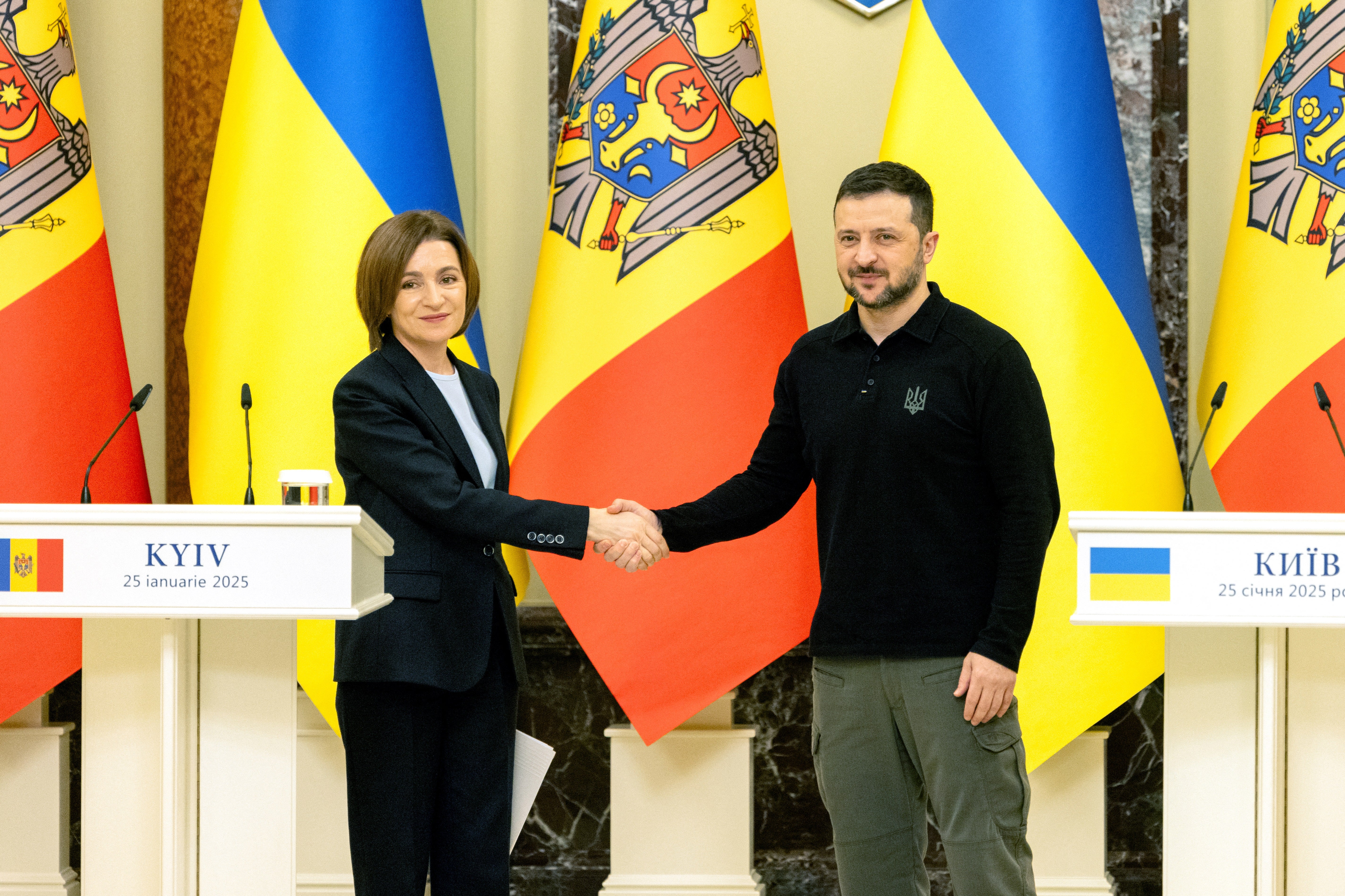 Moldova's President Maia Sandu and Ukraine's President Volodymyr Zelensky shake hands ahead of their meeting in Kyiv on Saturday