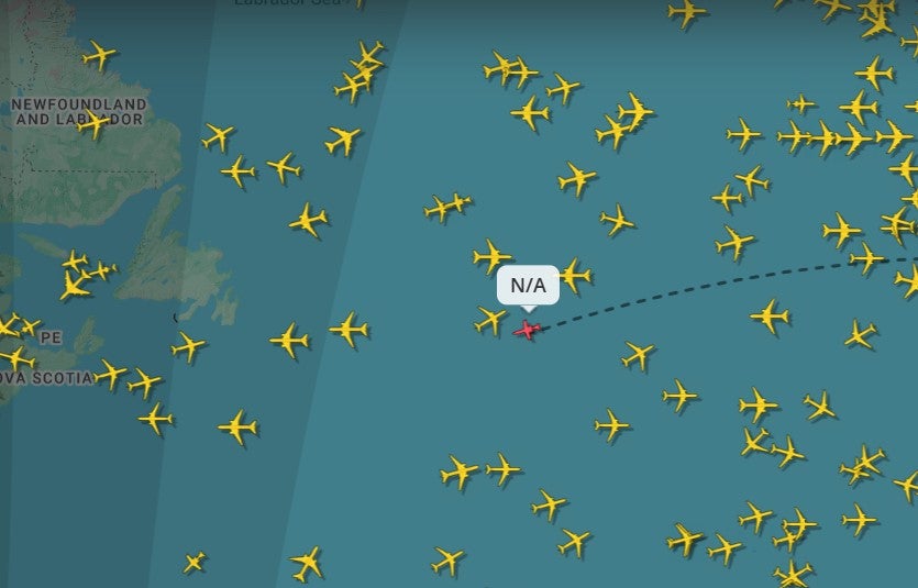 A live flight tracker shows the aircraft over the Atlantic Ocean