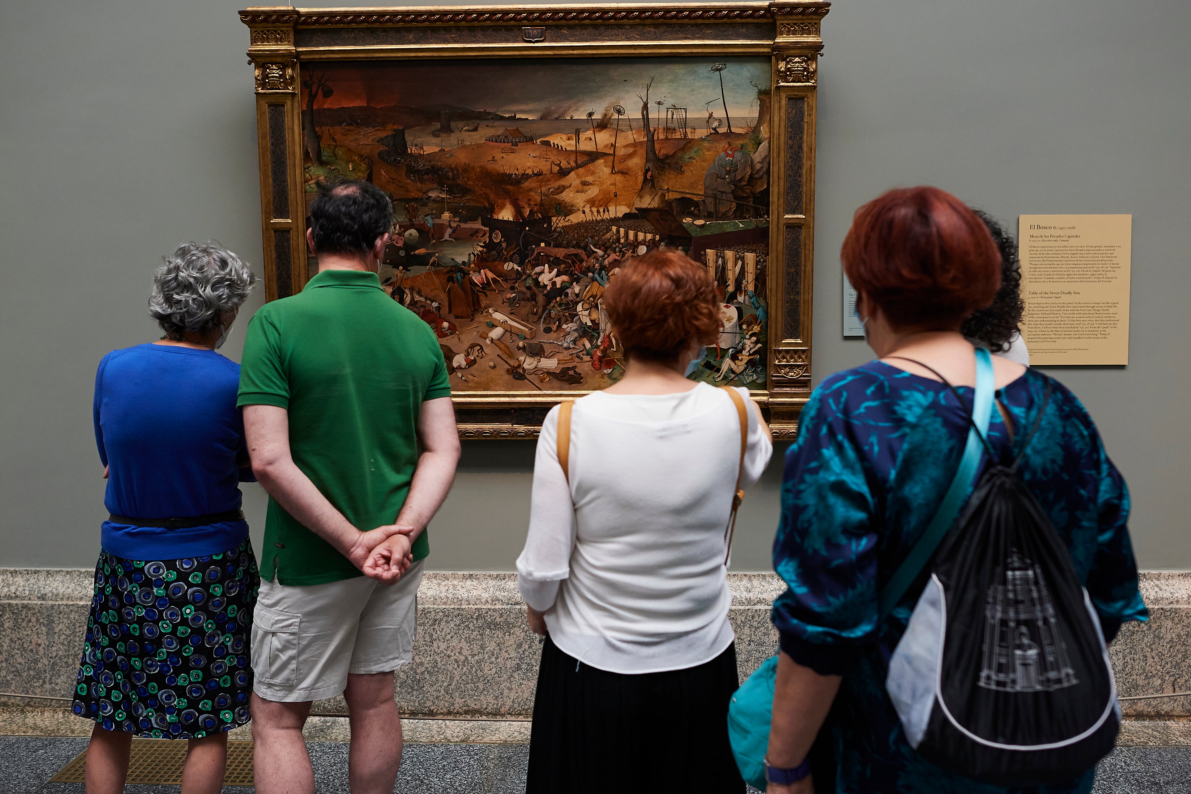 Visitors look at the Pieter Bruegel painting 'The Triumph of Death'