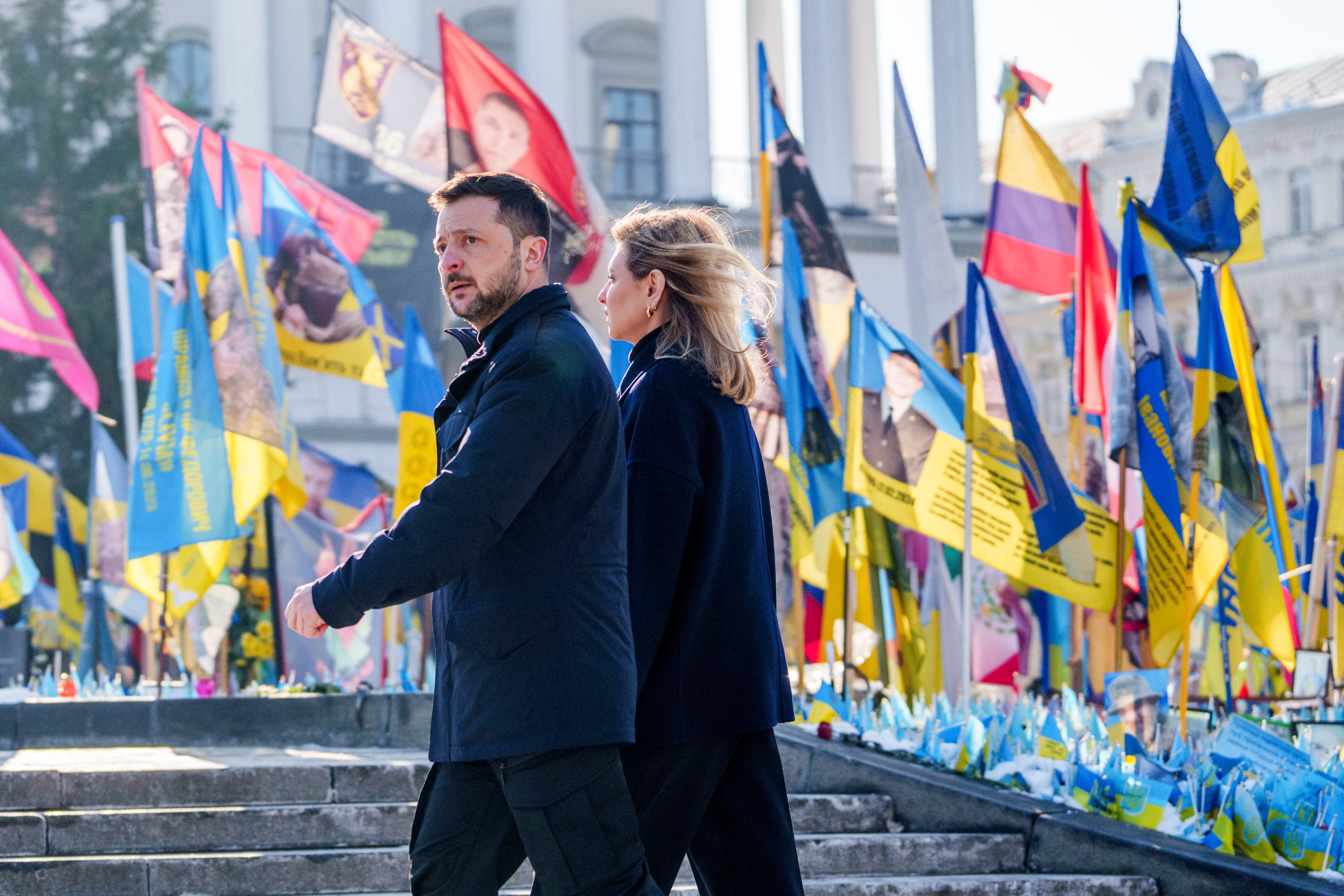 Ukrainian President Volodymyr Zelensky (L) and his wife, Ukraine's First Lady Olena Zelenska are pictured at Maidian Square in Kyiv