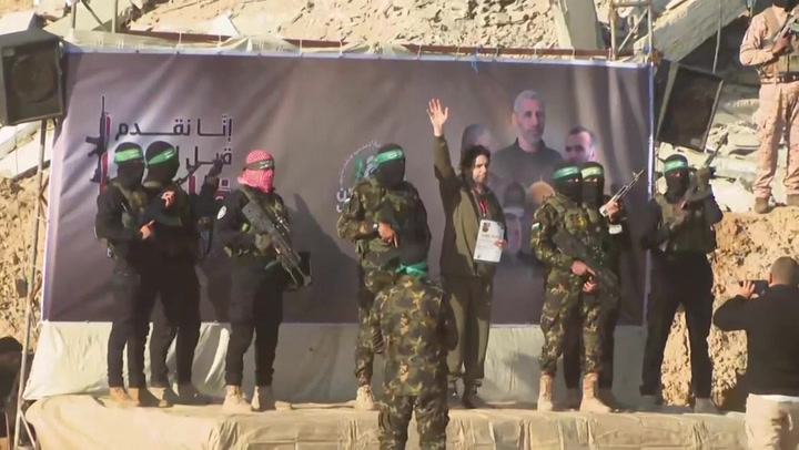 Watch: Hamas militants hand over Israeli hostages to Red Cross under ceasefire deal