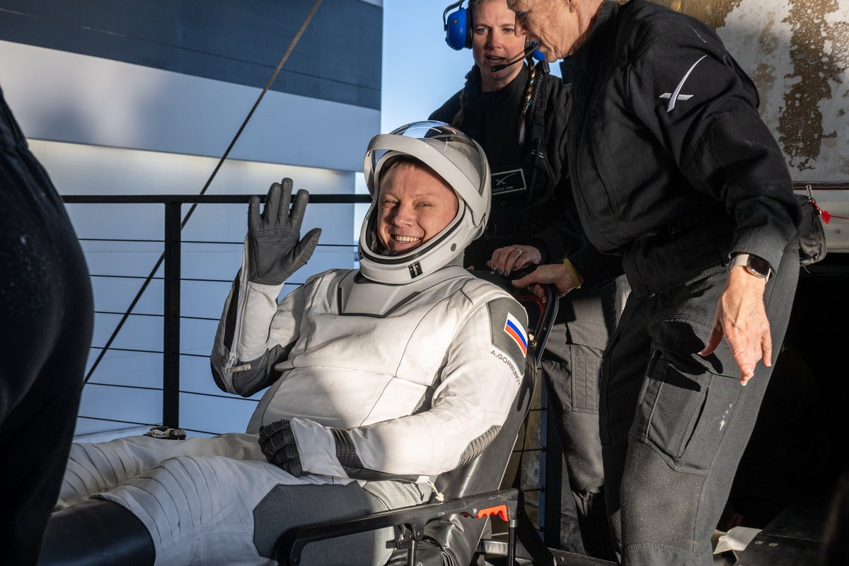 Astronauts return to Earth for first time in nine months – and are met by dolphins