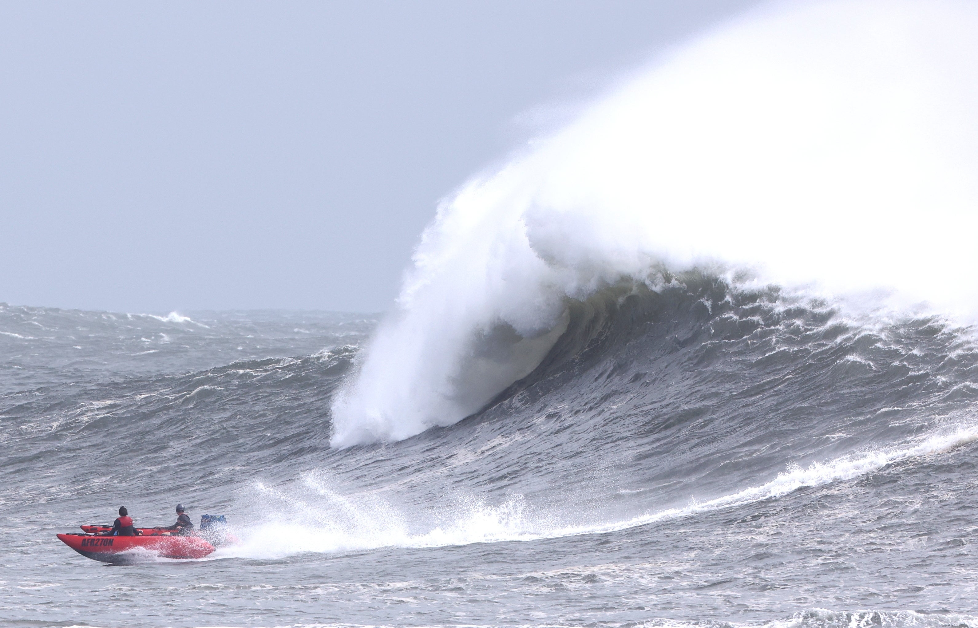 A boat in the water at Kirra during high surf from Tropical cyclone Alfred on the Gold Coast, Queensland