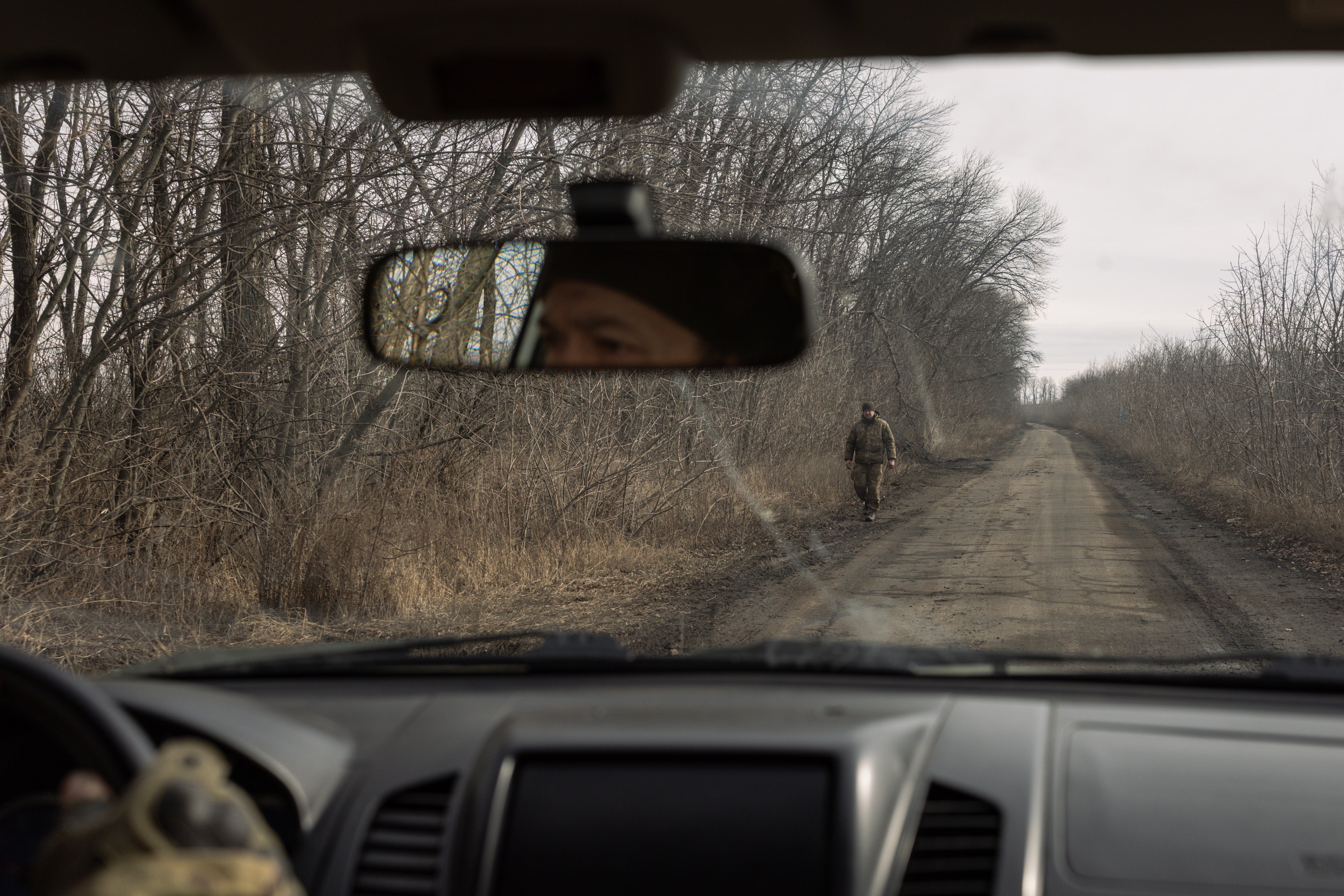 A service member of Ukraine's 13th Brigade Khartiia drives towards an American supplied M101 howitzer firing position in the Kharkiv region