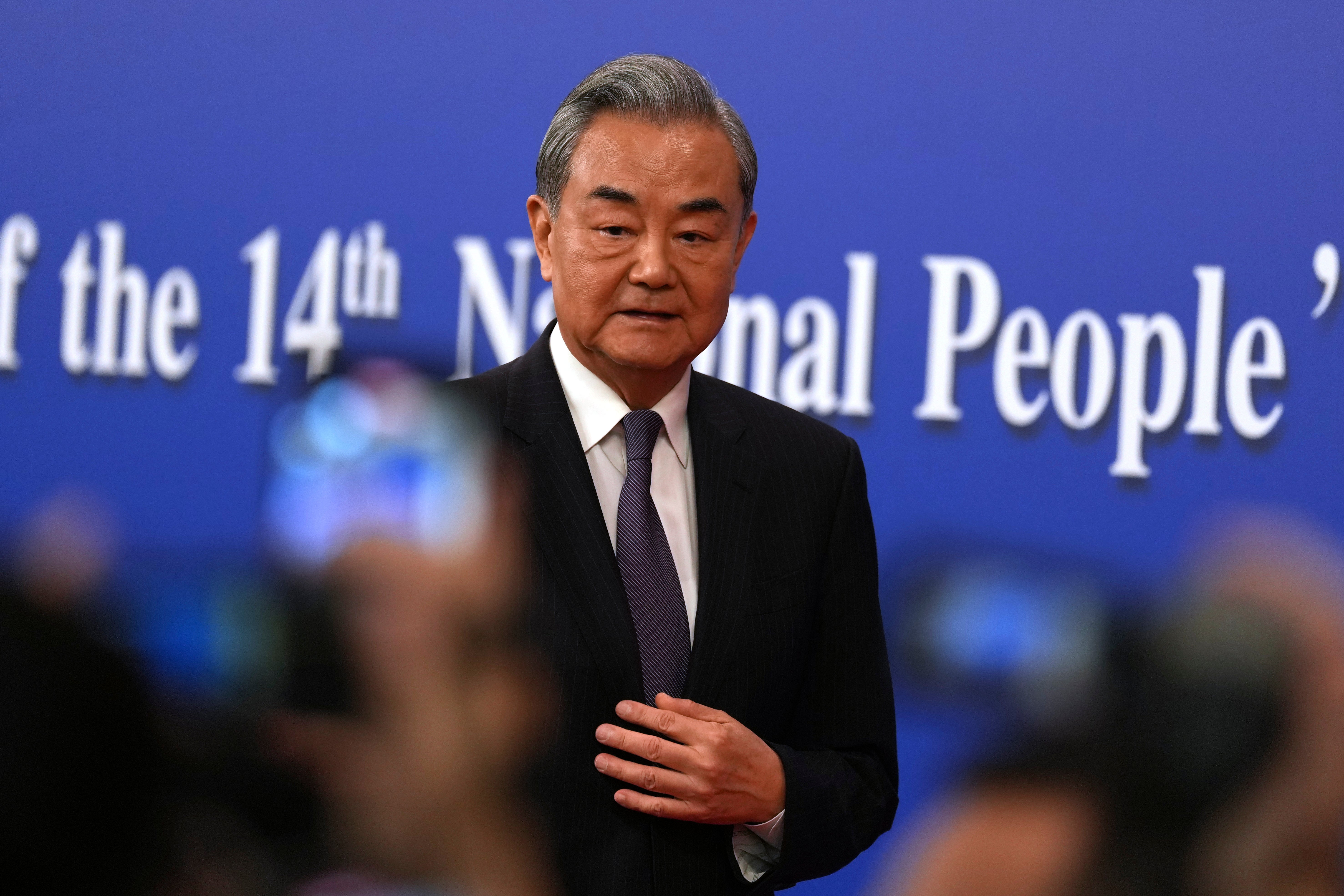 Chinese Foreign Minister Wang Yi leaves a press conference on the sideline of the National People's Congress in Beijing