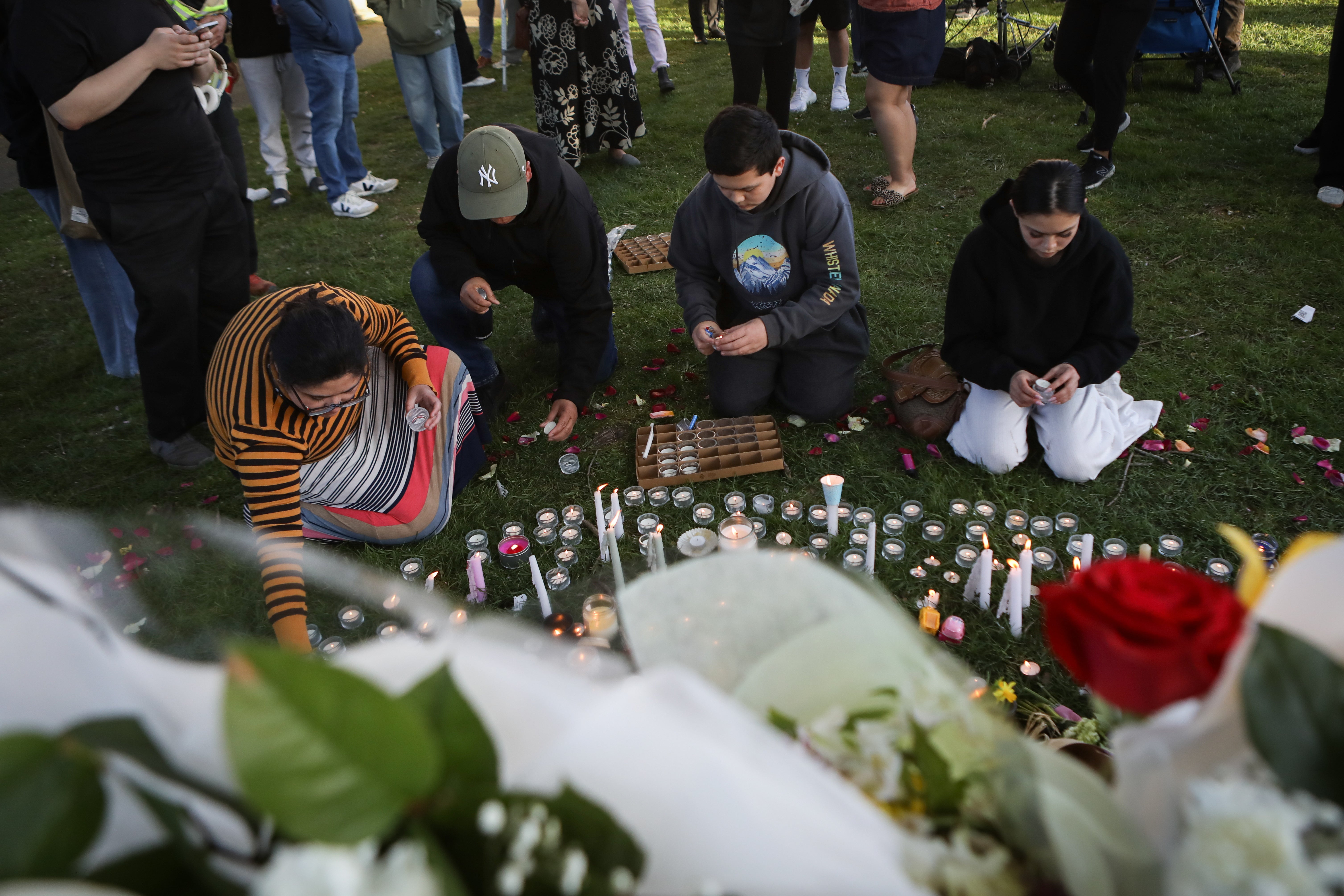 Mourners visit a make-shift memorial