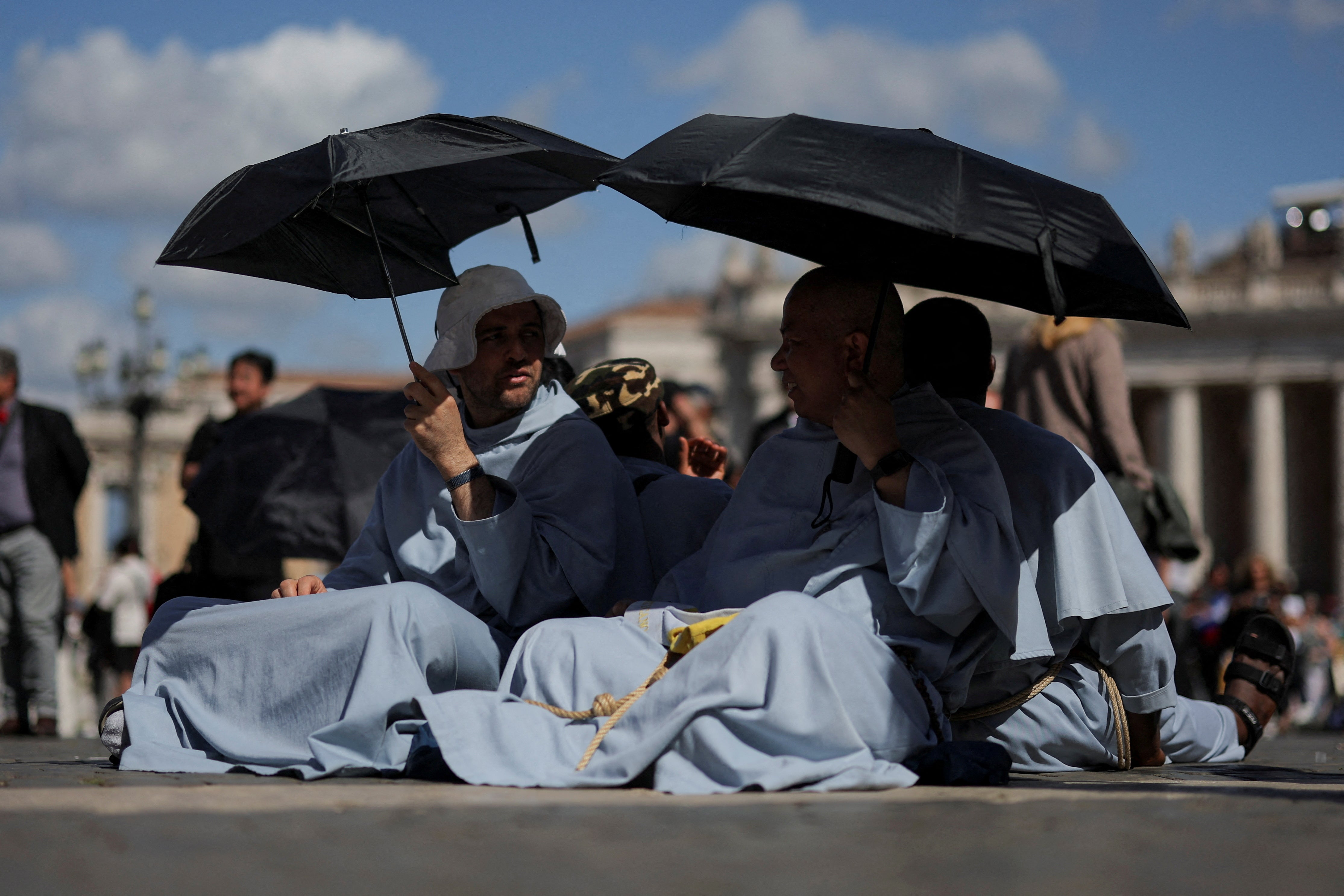 People wait in St Peter's Square for a smoke signal from the conclave