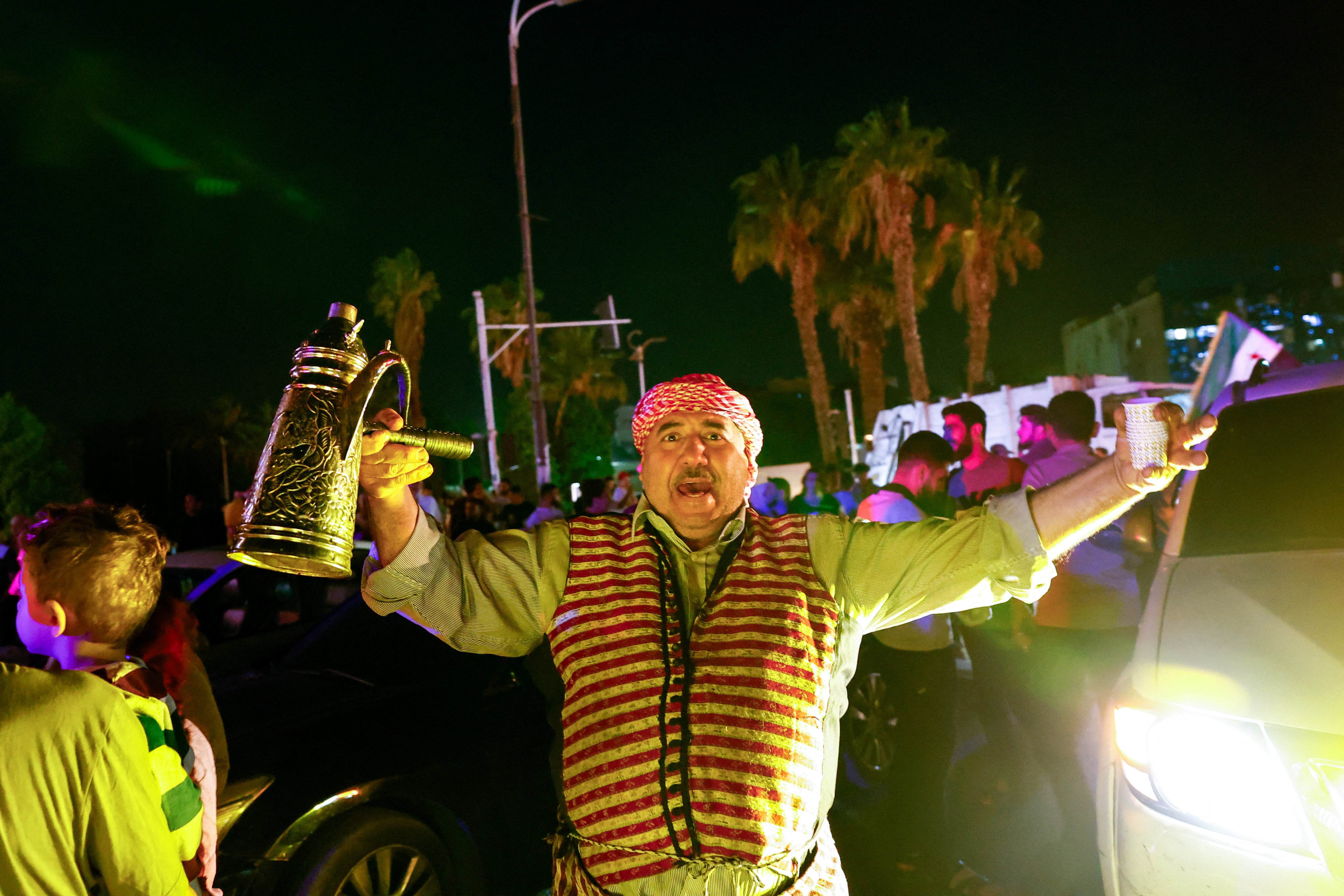 People celebrate after U.S. President Donald Trump said on Tuesday he would order the lifting of sanctions on Syria, in Damascus, Syria May 13 , 2025
