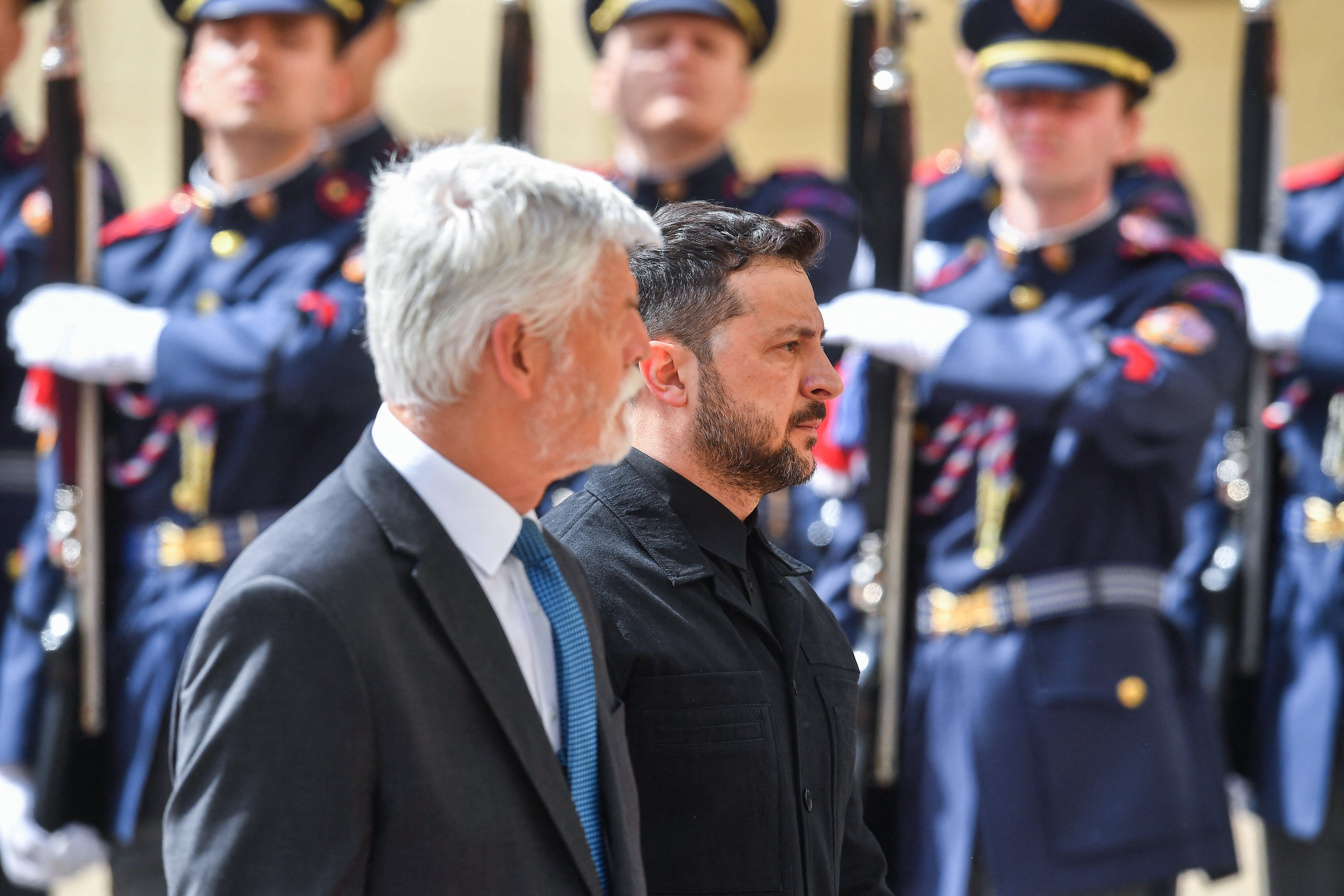 Czech president Petr Pavel and Ukrainian president Volodymyr Zelensky review a military honor guard in front of Prague Castle in Prague